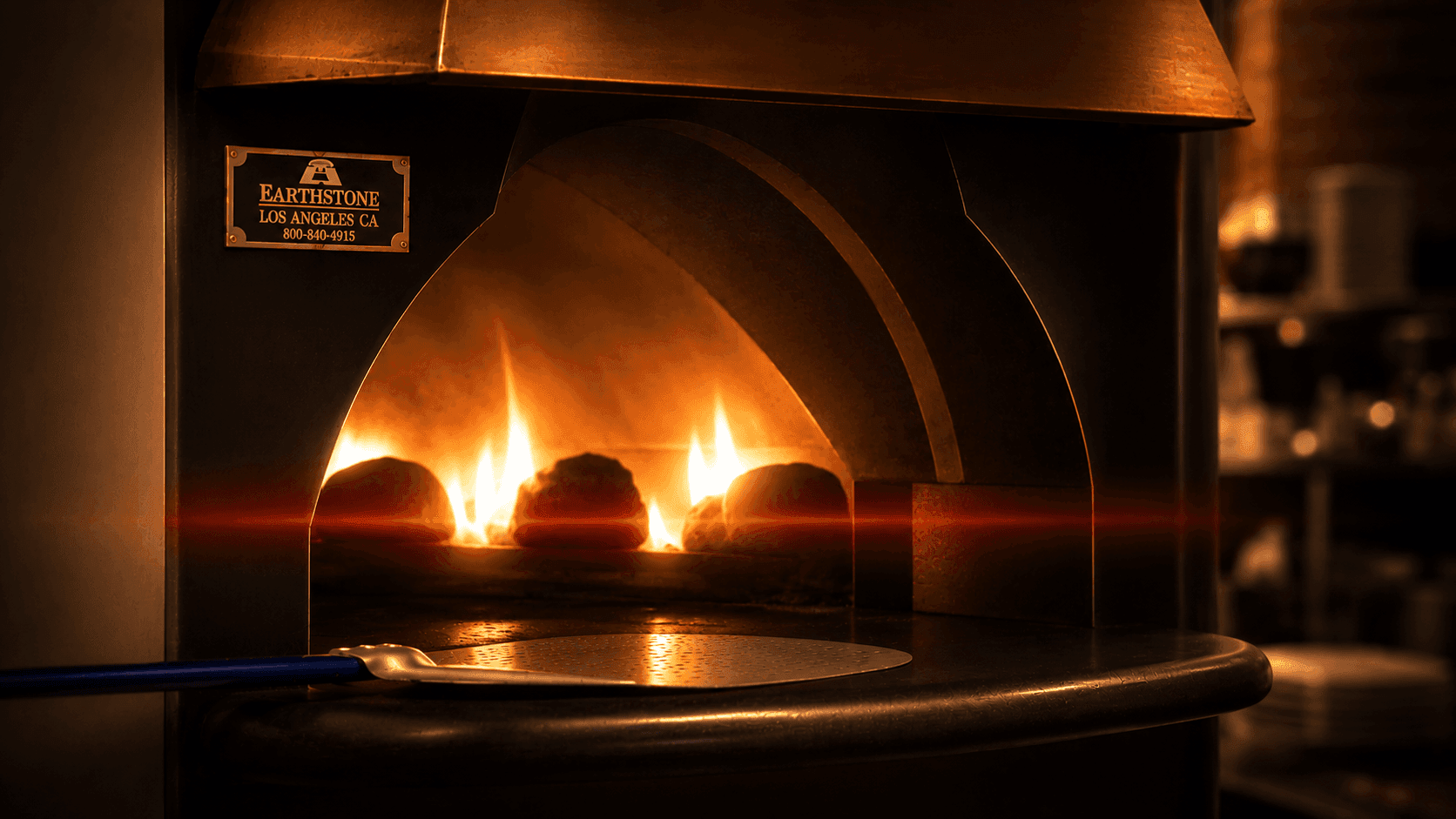 Flames glaring inside the stone pizza oven