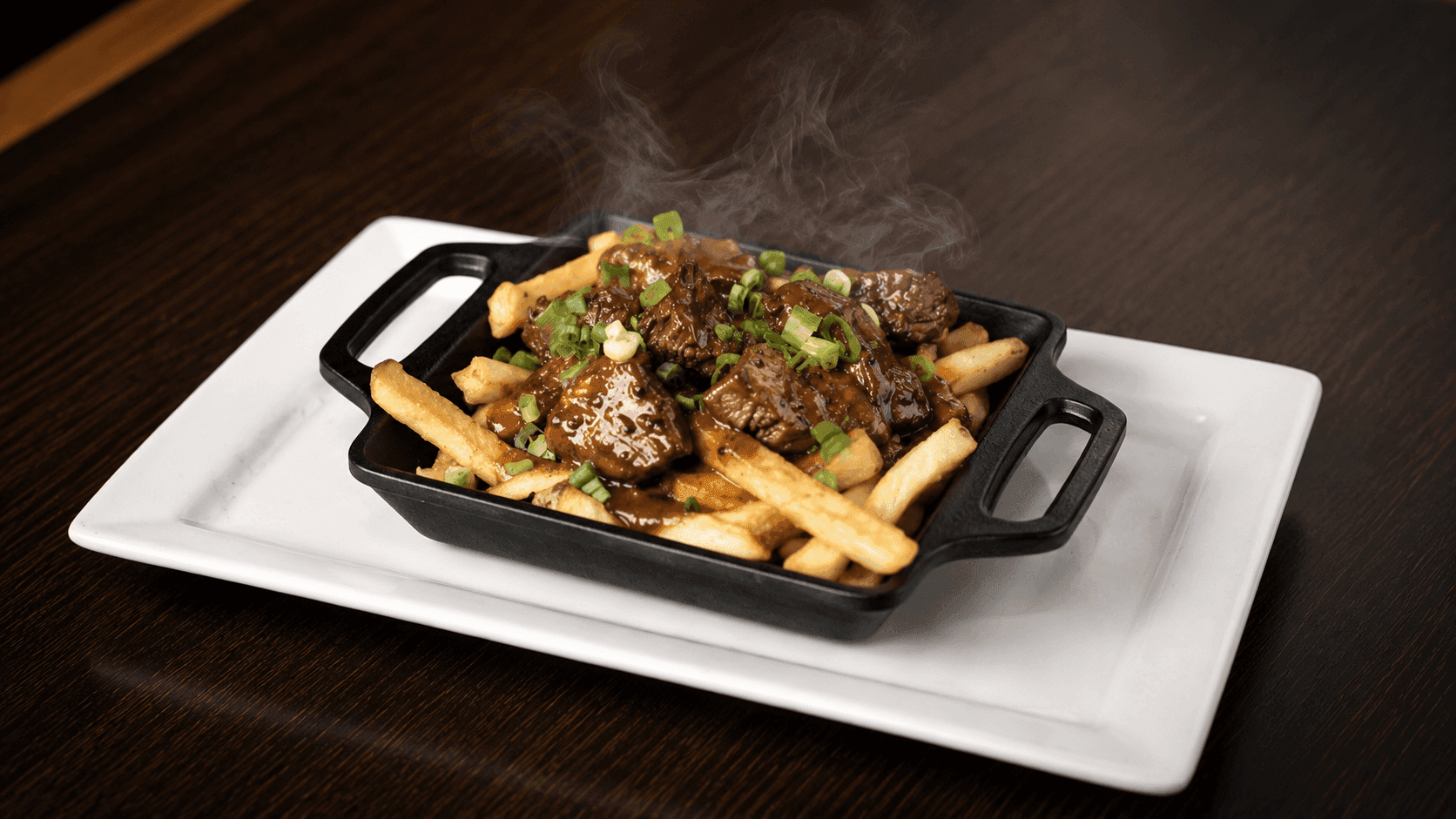 Cajun tenderloin steak tips on a bed of fries