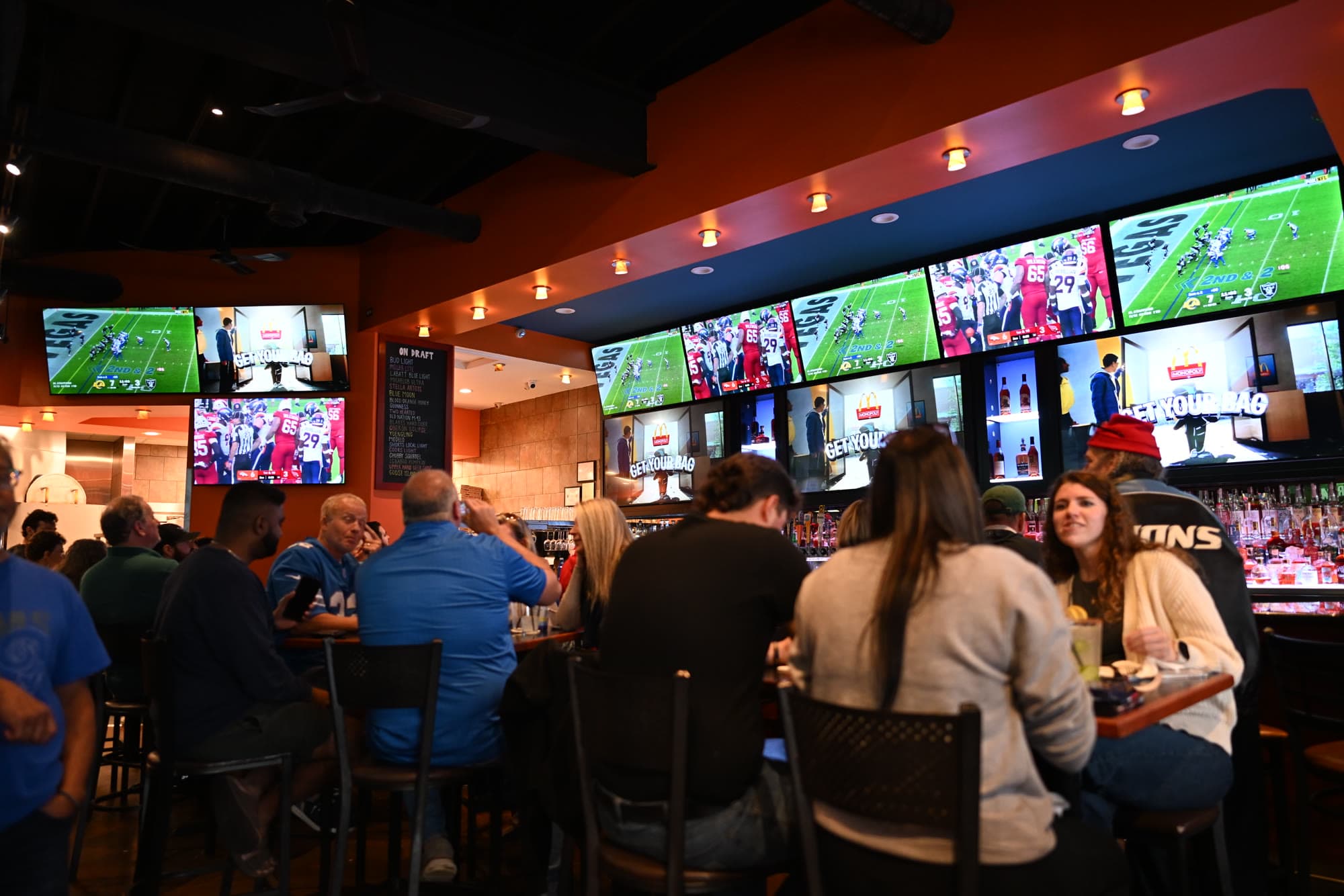 A packed house facing the wall of screens