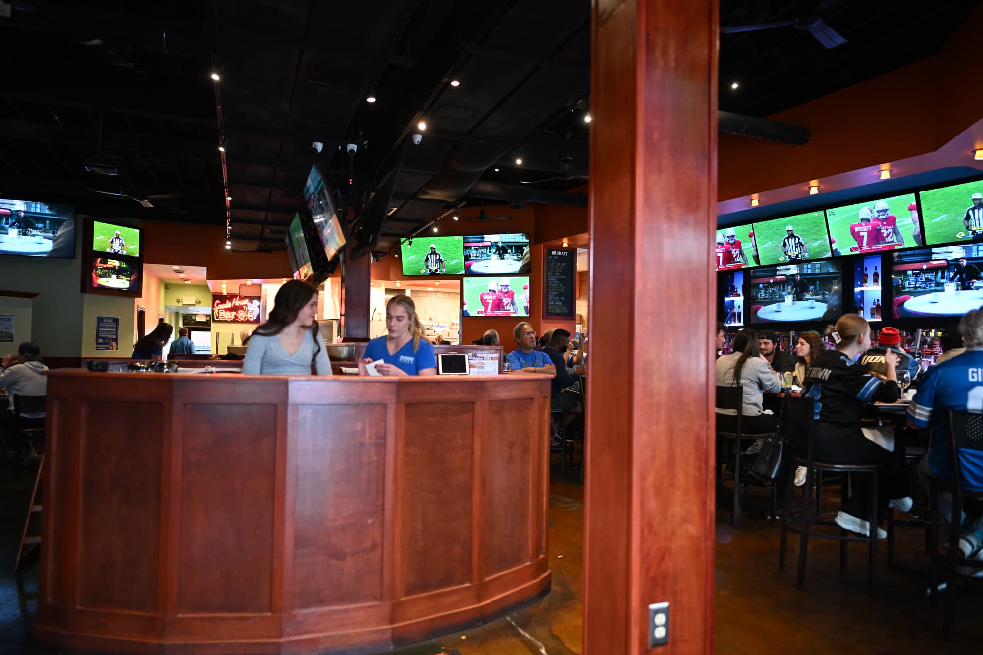 The bar with the game on behind it